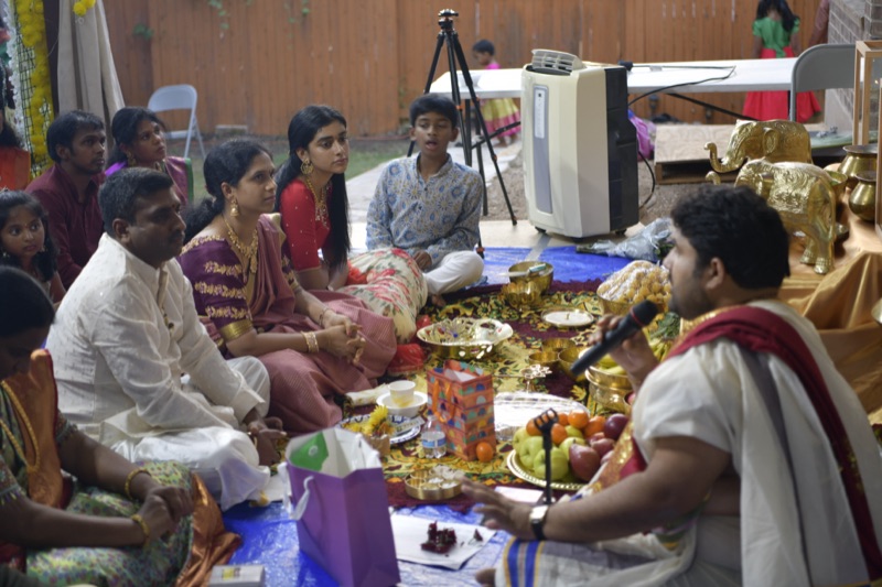 Priest conducting ceremony with family