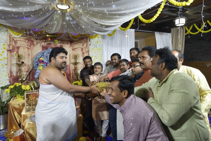 Priest blessing devotees at community event