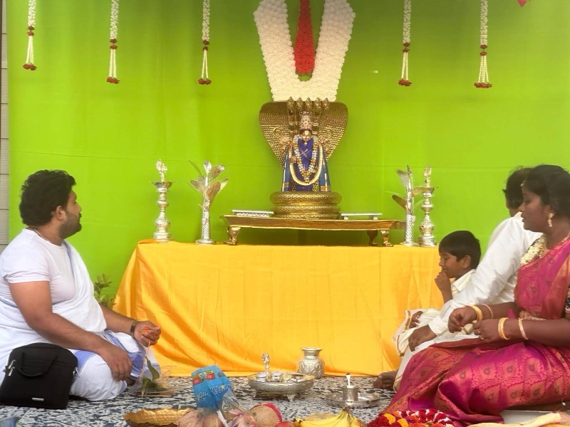 Deity with garlands and green backdrop