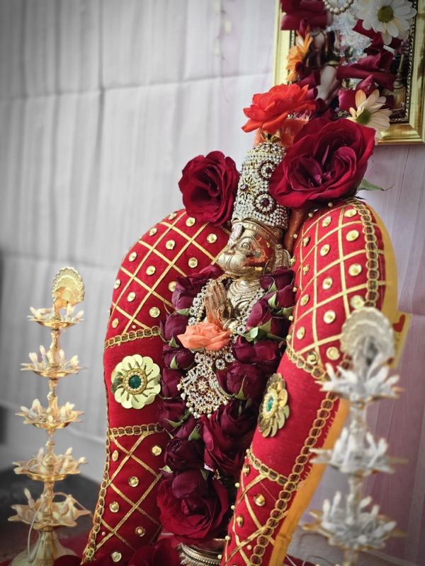 Deity adorned with roses and jewels